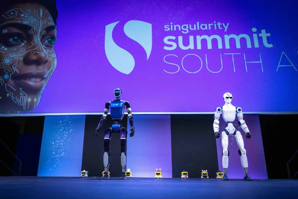 Singularity South Africa Summit 2026: Day 1 Roundup Blue and white humanoid robots displayed on stage at Singularity South Africa Summit 2026.