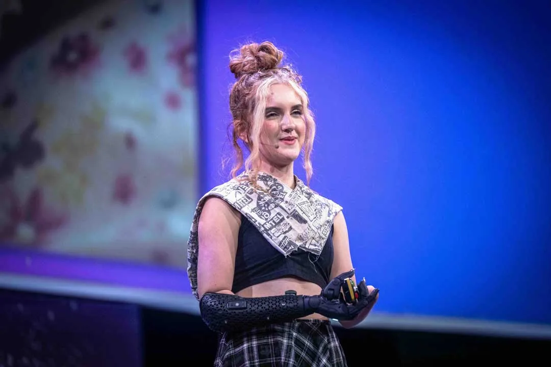 Tilly Lockey demonstrates a bionic prosthetic arm while speaking at Singularity South Africa Summit 2026.